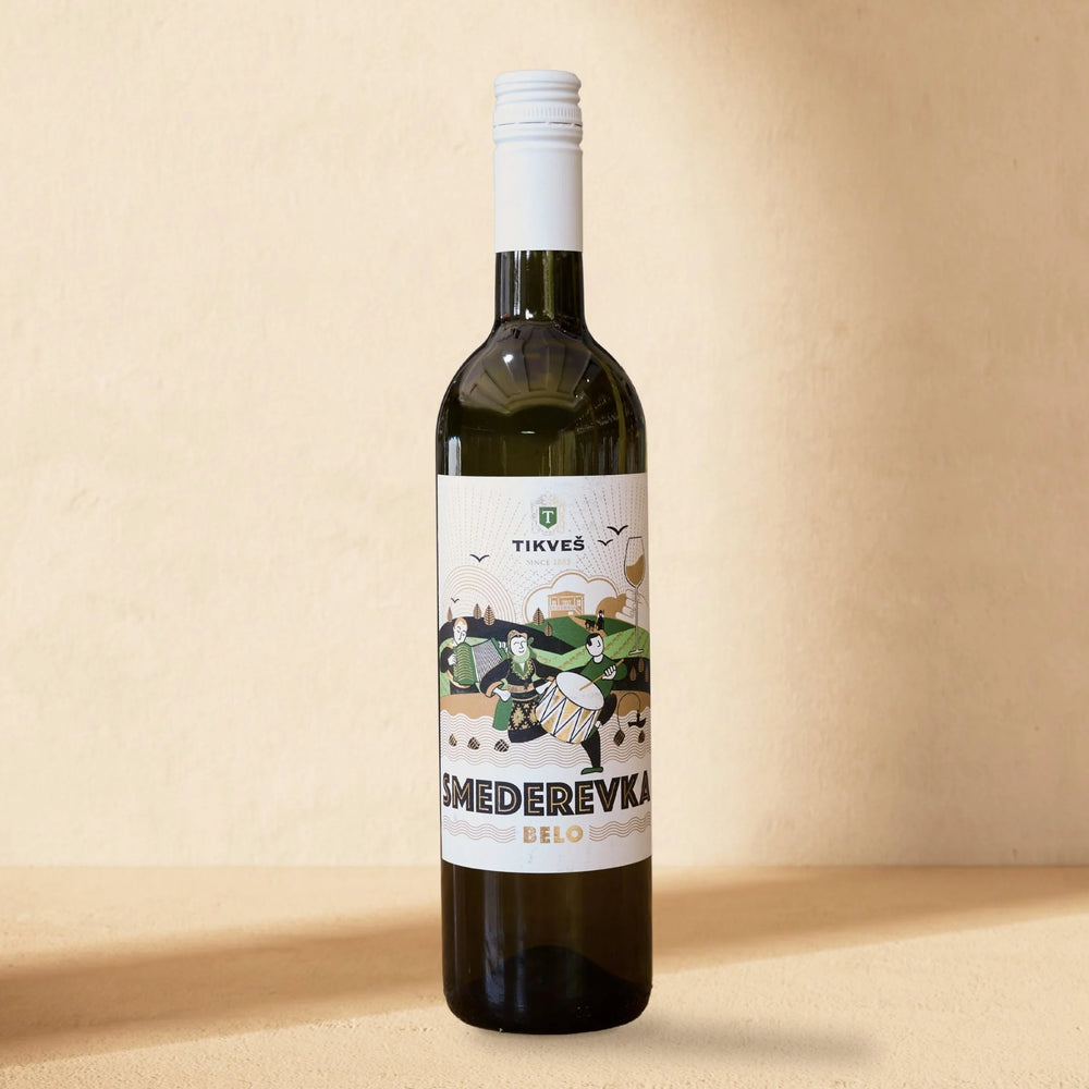 A bottle of Smederevka standing against a cream wall in soft window light