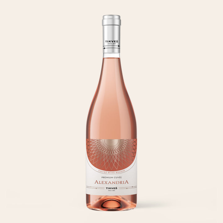 Bottle of Tikveš Alexandria Premium Cuvée Rosé, a dry rosé wine, on a cream background