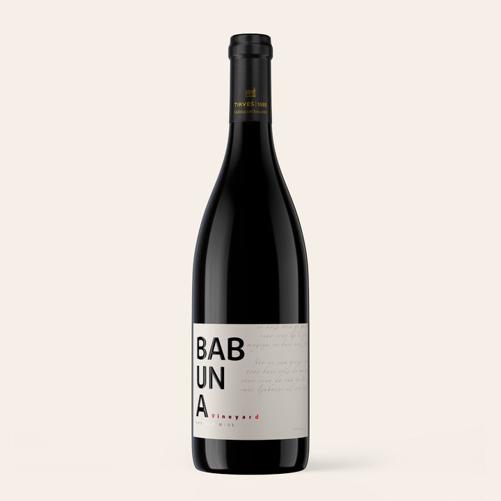 Bottle of Babuna Red, a Macedonian red wine from Tikveš, on a cream background