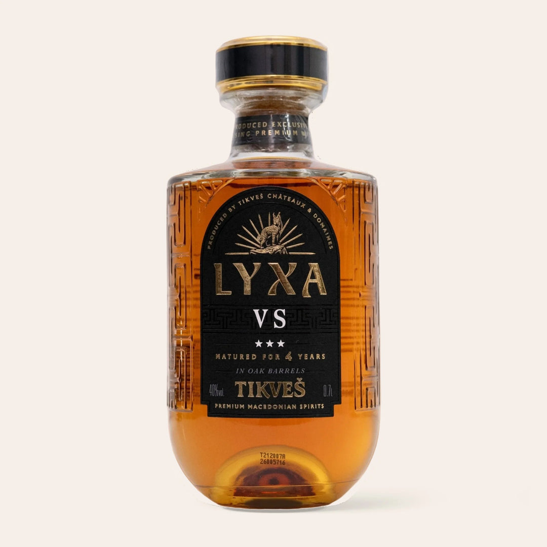 Bottle of LYXA VS, oak-aged Macedonian grape brandy from Tikveš Winery, on a cream background